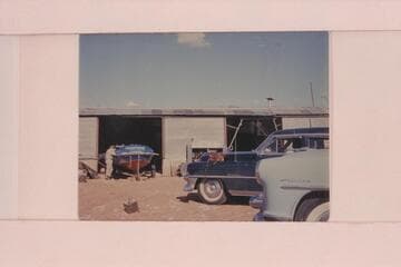 The "CACTUS" in the shop at Fredonia. Ed I'Anson leans on the boat and Rod Sanderson is beyond him