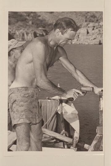 Norm Nevills shows some of the junk taken from the plateau in the Grand Canyon and which had been left there in 1944 by the aviators who had parachuted to the canyon at night