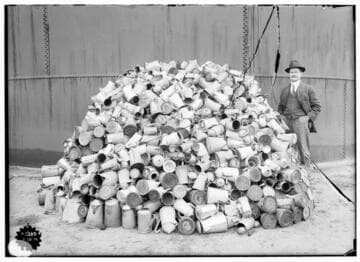 Edison Scrap Drives - A man standing beside a pile of junk coffee pots. The image is almost identical to that of 02