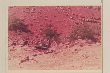 The "Rattlesnake" in Hance Rapid. Rod Sanderson is piloting, John Doerr sits starboard, Joe Desloge is center and Hugh Cutler is right