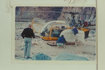 Dock Marston checks the Yak lashing to the helicopter as the pilot checks the whole operation. 217 Mile Rapid