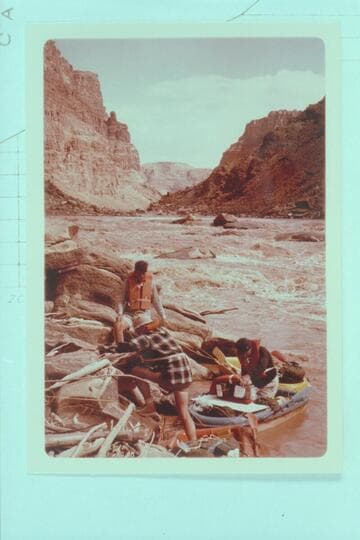 Upstream from foot of first drop of Rapid No. 23 which heads at Mile 202.20 and drops 9 ft. in 0.14 miles. The Sliced Boulder is at right margin. Buzz and Bill Belknap and Dock Marston work the Sportyaks. Low water divides the rapid into 2 drops