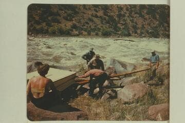 Portage at Hells Half Mile. Fern Frost at left; Kent in checked shirt; Frank Wright with straw hat; Alf Frost behind Frank; Wayne McConkie at right