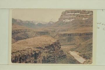 Down to mouth of 220 Mile Canyon. A snow-covered Diamond Peak in distance