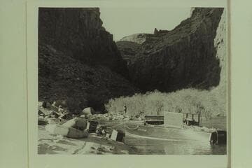 Fishing at camp at the mouth of Tapeats Creek. Left to right: Desloge, Forcier and Marston. The motorboat in the lagoon