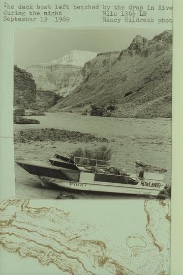 The deck boat left beached by the drop in river level during the night. Mile 136 1/2 left bank