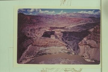 Whitmore Wash at left. Queantoweap Valley at top with the cinder cone at upper right. The Whitmore trail drops off the rim at center and crosses the basalt to end on the bech at lower right