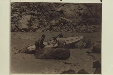 Working the "WEN" off the rocks in Marble Canyon, Mile 24-25. Nevills sits at left, Southworth wears the white shirt