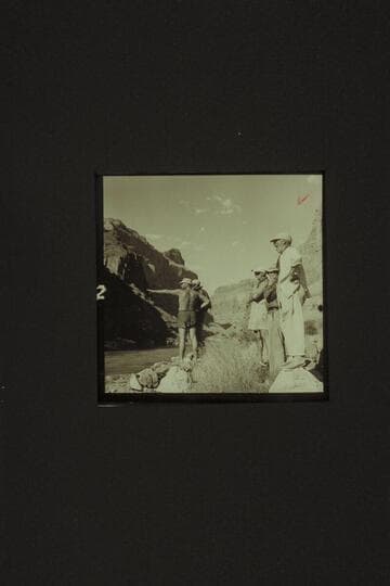 Belknap outlines his selected path through Lava Falls to Rod Sanderson at left. Masland sees the "Rocks, Rocks." Taylor wonders if it is a riffle and Marston appears bored but he isn't. Lava Falls from the left bank