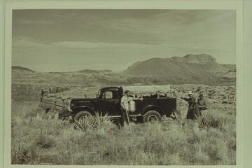Bill Belknap's Power Wagon on The Rim, south side above Lava Falls. Jorgen Visbak stands next to the truck