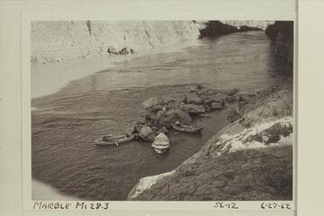 The Mortenson-Reilly-Litton boats landed at Mile 28.3. The rocks are part of the fan appearing in the Hillers photo 445