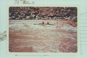 Jean and Hal Bennett run out of lower end of Rapid #22. Note round-topped boulder upper right. 10,430 cfs