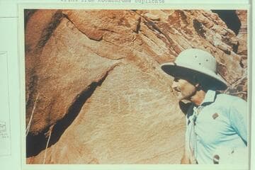 Harry Aleson looking at the Hite inscription at a small indent at Mile 143.9 RB in Glen Canyon