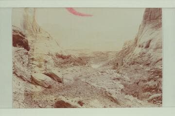 Hole in the Rock. The men were likely part of the crew in the previous picture showing the Hole in the Rock from below. From Stanton collection