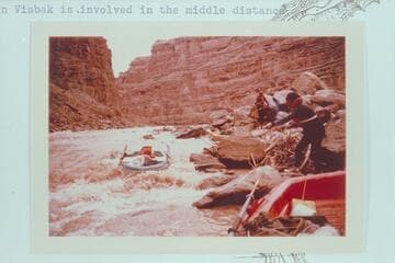 Dock Marston lines a Yak in Dark Canyon Rapid. Jorgen Visbak is involved in the middle distance