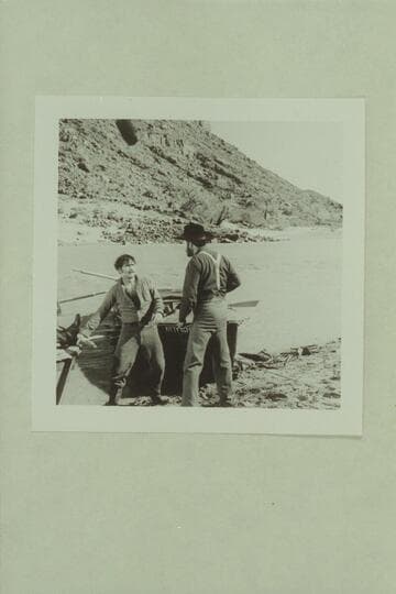 Walter Powell (played by Jim Drury) prepares to swing on Major Powell (played by John Beal). Actionin the Disney filming of "The Colorado River Story." Colorado River near Castle Creek above Moab