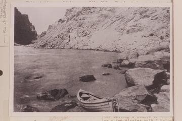 Brown-Stanton boat on the rocks at head of Rapid No. 23, Mile 202.20. Caption reads: No. 54. Railway Survey, Colorado River, 1889. Sta. 8735 UP. 46