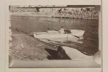 Ellsworth Kolb in boat below Rapid #4, Cataract Canyon. U. S. Geological Survey under W. R. Chenowith