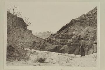 Kent Frost standing above first drop in Red Lake Canyon, also known as Butler Canyon. He looks across to the Land of the Standing Rocks across the Colorado River. Kent stands on ca. the 4560ft. contour as shown in the map Carlisle 3 NW Utah