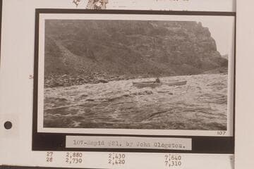 USGS boat in Rapid No. 21 which heads at Mile 202.8 and drops 10 ft. in 0.25 miles. Mouth of Teapot Canyon. Print No. 107 in LaRue album in Huntington Library