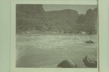Looking up the Green River at top of Upper Disaster Rapid. One of the sadiron boats of Reynolds is approaching the head of the rapid