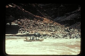 George Wing frees the Nevills San Juan punt from rock near Johns Canyon. MH gauge: 1190 cfs