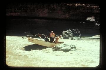George Wing hung with San Juan punt on rock near Johns Canyon. MH gauge: 1190 cfs