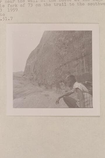Chris Turner near the wall of the butte at the edge of the middle fork of 73 on the trail to the southwest fork