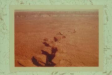 Coyote Gulch from over the point where it joins the Escalante River. The Straight Cliffs of Fifty Mile Mountain are at top