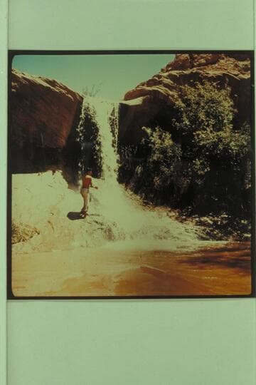 Waterfall in Lake Canyon 5.5 miles from the river. Henry Silversmith, a Navajo from Chinle. Arizona appears at the fall