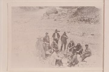 Part of the Pathe-Bray Co. Dick Muller and Ray Tankersley in background. Dick with coffee cup almost to mouth. Jack Harbin is seated with clasped hands just to right of Dick Muller. John Boles is seated second from right