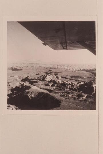 Down Cha Canyon from the air above the trail north of Navajo Mountain. Cha Canyon flows into the San Juan River at Mile 11.5. The Henry Mountains on the skyline- Waterpocket Fold is this side of the Henry's