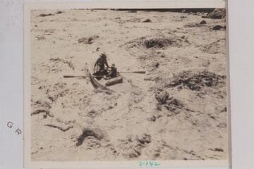 A skiff of the Dusty Dozen party in the lower end of Grapevine Rapid. The boatman is running bow first and carrying a passenger