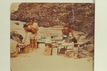 Breakfast at camp at Switching Yard. John Schulz sits at edge of picture. Garth Marston leans down for some food. Chuck Richey. Larry Sanderson pours coffee