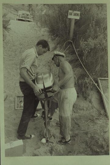 Bill Beer and Rod Sanderson nursing a motor into shape for the Grand Canyon cruise. Lees Ferry
