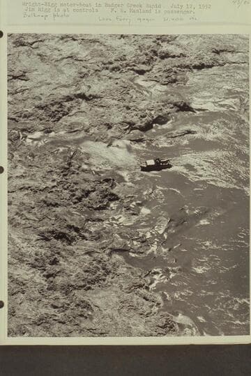 Wright-Rigg motorboat in Badger Creek Rapid. Jim Rigg is at controls. F. E. Masland is passenger