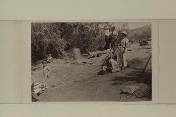 At left, Sandra Nevills walks down to christen the sadiron named for her. Lees Ferry. Dock Marston stands at the camera tripod