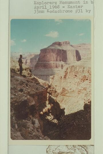 On left cliff of Royal Arch Canyon. Explorers Monument in background