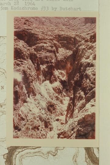 In the Redwall in side canyon at Mile 148.5. The drop-offs are below this