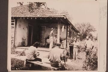 Ruple Ranch; Island Park. Sitting in foreground are Loel Marston and Willie taylor. On the porch are Shirley Marston and Rosalind Johnson. Elma and Al Milotte stand right center. Norm Nevills stands in front of Joel