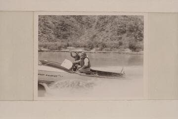 The "Sweet Chariot" cruising on upper Lake Mead in the Grand Canyon at the end of the 1951 motor traverse. Cooper is pilot. Taylor facing the camera