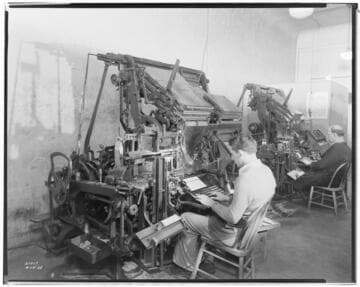 Two men typing on Linotype machines