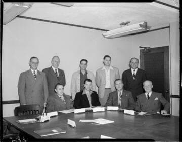 Posed photograph of 9 officers in Edison board room