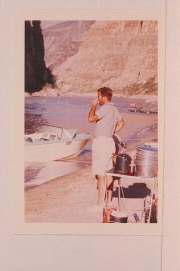 George Morrison works at getting awake. Camp at foot of Vulcan Rapid