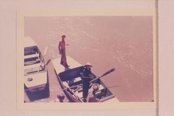 Norm Nevills in a characteristic pose on the deck of one of his San Juan punts