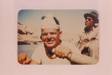 Boatman George Wing at the oars. Max Krueger in background. Max was regional geologist for Union Oil