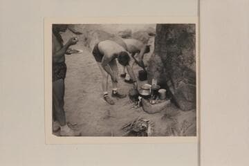 Breakfast at camp at Mile 19; right bank. Marston stands left and Ed Hudson and Willie Taylor dish up some mix of concentrates
