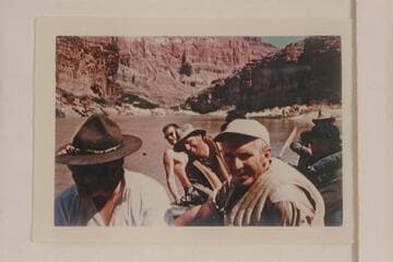 Crew of the Hatch-Dines party. Walt Emery wears the campaign hat. Bruce Dines wears no shirt. Smuss Allen wears hat in center. Smokey Patten in foreground. Allan Smith in rear hidden by Jim Nelson. Eight rode in the pontoon