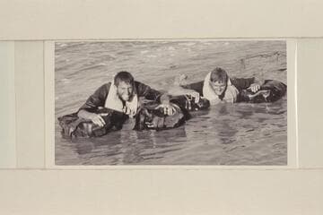 Daggett and Beer demonstrating their water wings with which they traversed the Grand Canyon in 1955, Apr.-May. Lower end of Grand Canyon about 2 miles above Emory Falls