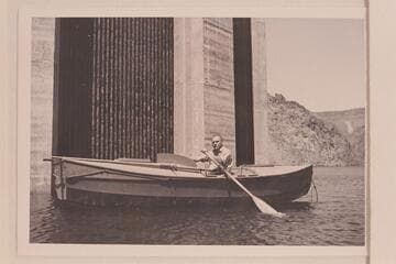 Buzz Holmstrom in his skiff, the "Julius F" after the end of the 1938 run from Wyoming to Lake Mead. He was permitted to row down to the face of Hoover Dam for the publicity possibilities